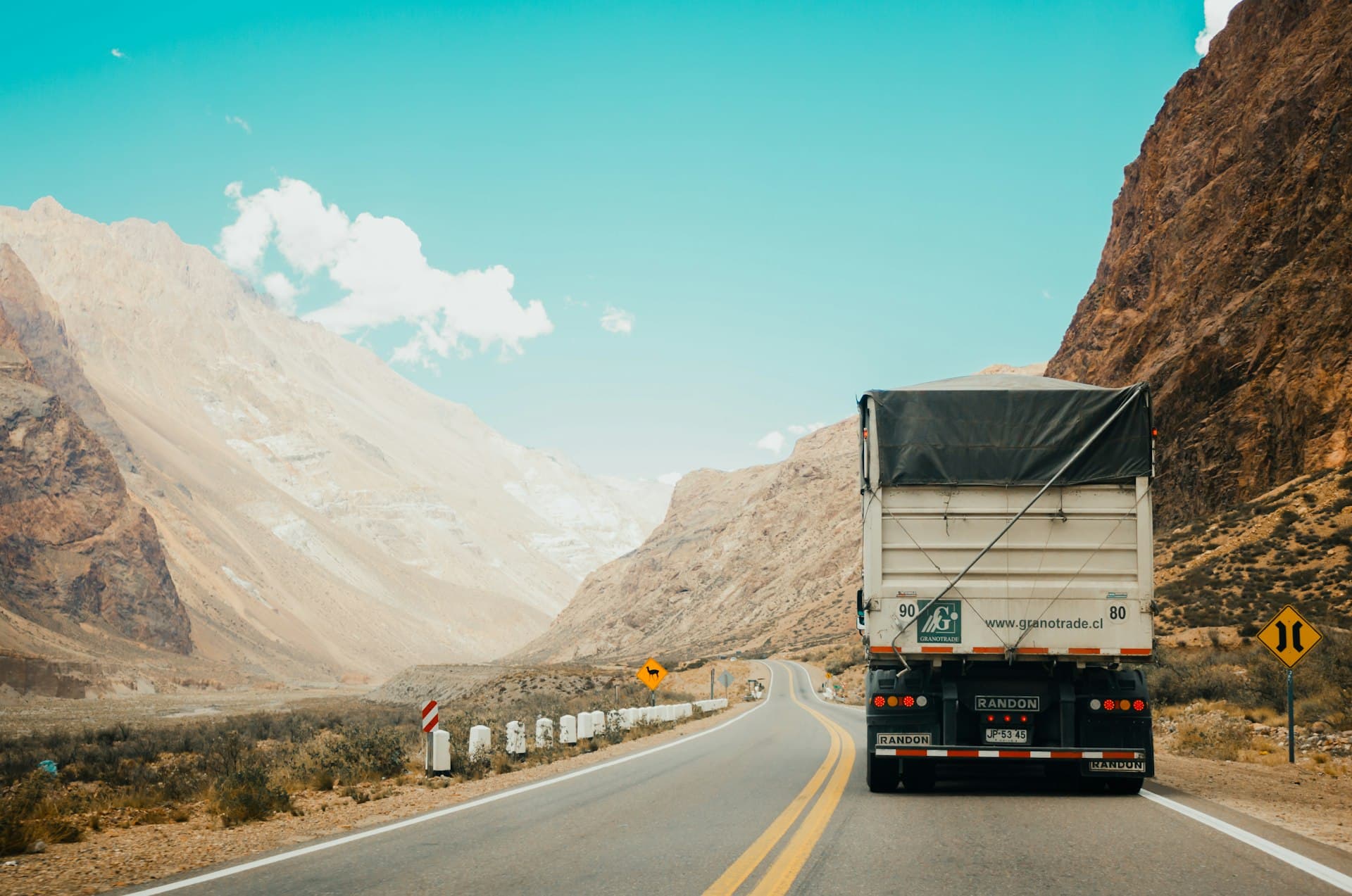 Commercial transport lorry carrying industrial goods on a long-distance national highway
